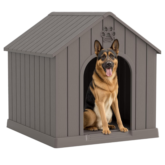 Gray plastic dog house with peaked roof and paw print decoration, German Shepherd sitting in entrance.