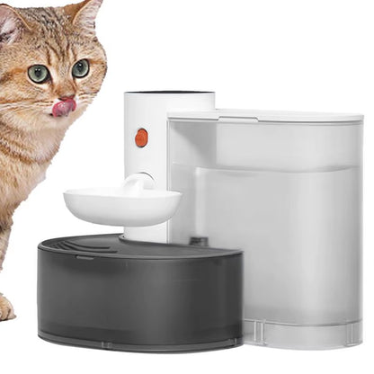 Orange tabby cat with tongue out next to white and black multi-tier automatic water fountain dispenser with bowl.